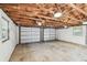 Spacious two car garage features an exposed rafter ceiling and bright lighting at 483 32Nd N Ave, St Petersburg, FL 33704