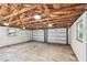 Spacious two car garage features an exposed rafter ceiling and bright lighting at 483 32Nd N Ave, St Petersburg, FL 33704