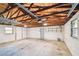 Spacious two car garage features an exposed rafter ceiling and bright lighting at 483 32Nd N Ave, St Petersburg, FL 33704