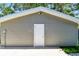 Exterior of a gray garage featuring a white door at 483 32Nd N Ave, St Petersburg, FL 33704