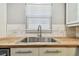 Close-up of the kitchen sink with butcher block countertops and white cabinetry at 483 32Nd N Ave, St Petersburg, FL 33704