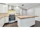 Modern kitchen features stainless steel appliances, center island with wood countertop and white cabinetry at 483 32Nd N Ave, St Petersburg, FL 33704