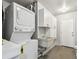 Laundry area has stacked washer and dryer and storage cabinets at 483 32Nd N Ave, St Petersburg, FL 33704