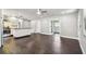 Open floor plan with dark wood floors connecting the living room and kitchen spaces at 483 32Nd N Ave, St Petersburg, FL 33704