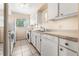 The well-lit kitchen features white appliances, storage cabinets and tile flooring at 501 E Bay Dr # 802, Largo, FL 33770