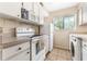 Well-lit kitchen featuring white appliances, cabinetry and tile flooring at 501 E Bay Dr # 802, Largo, FL 33770