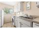 Bright laundry area features a sink, plenty of counter space and lots of storage cabinets at 501 E Bay Dr # 802, Largo, FL 33770