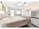 Bright main bedroom with neutral tones, ceiling fan, and walkout access at 501 E Bay Dr # 802, Largo, FL 33770