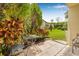 Private patio with table and chairs surrounded by lush landscaping in backyard at 501 E Bay Dr # 802, Largo, FL 33770