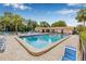 Community pool with lounge chairs and clubhouse under bright blue skies at 501 E Bay Dr # 802, Largo, FL 33770