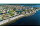 Stunning aerial view of waterfront homes and canals, showcasing the desirable coastal community with a private beach at 5030 Herring Ct, New Port Richey, FL 34652