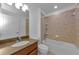Bathroom featuring a single sink vanity, and a bathtub with tiled walls at 5030 Herring Ct, New Port Richey, FL 34652