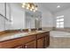 Bathroom featuring double sinks, granite countertops, soaking tub, and tile surround at 5030 Herring Ct, New Port Richey, FL 34652
