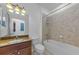 Bathroom featuring vanity with granite countertop and tiled shower-tub combination at 5030 Herring Ct, New Port Richey, FL 34652