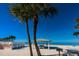 Picturesque beachfront featuring a covered picnic area, BBQ grill, and palm trees for a relaxing day by the sea at 5030 Herring Ct, New Port Richey, FL 34652