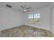 Bedroom featuring tile flooring, ceiling fan, and a window providing natural light at 5030 Herring Ct, New Port Richey, FL 34652