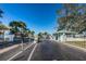 Secure gated community entrance with lush landscaping and a charming guardhouse, providing privacy and peace of mind at 5030 Herring Ct, New Port Richey, FL 34652