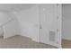 Clean, bright entryway featuring neutral tile floors, white walls, stairs, and a front door with a dog door at 5030 Herring Ct, New Port Richey, FL 34652
