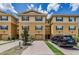 Beautiful townhome with tan stucco, brown shutters, and a paver driveway leading to a one-car garage at 5030 Herring Ct, New Port Richey, FL 34652
