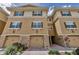Elegant townhomes featuring a neutral color, multi-story facade, private garages, and tasteful landscaping at 5030 Herring Ct, New Port Richey, FL 34652