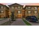 Townhome with tan stucco, brown shutters, and a paver driveway leading to a one-car garage at 5030 Herring Ct, New Port Richey, FL 34652