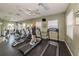 Community fitness center with treadmills, elliptical machines, weight machines, mirrors, and windows for an active lifestyle at 5030 Herring Ct, New Port Richey, FL 34652
