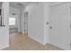Bright hallway with neutral tile floors, white walls, and doorways to adjacent rooms at 5030 Herring Ct, New Port Richey, FL 34652
