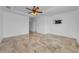 Spacious living room featuring tiled flooring, ceiling fan and neutral walls at 5030 Herring Ct, New Port Richey, FL 34652
