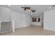 Open-concept living room with tile flooring, staircase, and views into the kitchen at 5030 Herring Ct, New Port Richey, FL 34652