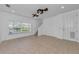 Bright living room featuring tiled flooring, a large window, and neutral paint at 5030 Herring Ct, New Port Richey, FL 34652