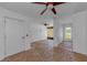 Bright living room featuring a brick floor, ceiling fan, and natural light at 5030 Herring Ct, New Port Richey, FL 34652