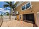 Back patio features pavers, a privacy fence, and access to the unit with lush landscaping at 5030 Herring Ct, New Port Richey, FL 34652