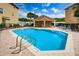 Community pool with inviting blue water, lounge chairs, and a covered seating area for relaxing and enjoying the outdoors at 5030 Herring Ct, New Port Richey, FL 34652