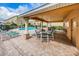 Community pool and covered seating area with lounge chairs and a clear view of the buildings at 5030 Herring Ct, New Port Richey, FL 34652