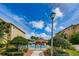 Gated community pool surrounded by lush landscaping and offering a refreshing escape for residents at 5030 Herring Ct, New Port Richey, FL 34652