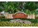 Welcoming community sign surrounded by lush landscaping, showcasing the charm of Sea Forest Townhomes at 5030 Herring Ct, New Port Richey, FL 34652