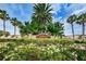 Community sign amid lush tropical foliage, creating a welcoming entrance to Sea Forest Townhomes at 5030 Herring Ct, New Port Richey, FL 34652