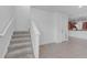 Carpeted staircase leading to the second floor, open to the dining and kitchen area at 5030 Herring Ct, New Port Richey, FL 34652