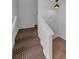 Carpeted staircase leading to tiled hallway at 5030 Herring Ct, New Port Richey, FL 34652
