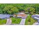 Aerial view of charming home with lush landscaping and a spacious lawn at 5102 Peacock, Holiday, FL 34690