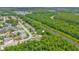 An aerial view shows the home's location near a river and a wooded area at 5102 Peacock, Holiday, FL 34690