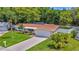 Beautiful single-story home with a lush, green lawn and mature landscaping at 5102 Peacock, Holiday, FL 34690