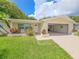 Charming single-story home featuring attached garage, manicured lawn, and well-kept landscaping at 5102 Peacock, Holiday, FL 34690