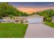 Charming single-story home with well-manicured lawn, mature trees, and a two car garage at 5102 Peacock, Holiday, FL 34690