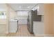 Modern kitchen with white cabinets, stainless steel appliances, and wood look flooring at 5102 Peacock, Holiday, FL 34690