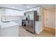 Updated kitchen features stainless steel appliances, quartz countertops, and crisp white cabinetry at 5102 Peacock, Holiday, FL 34690