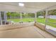 This screened lanai features a concrete floor and views of the backyard at 5102 Peacock, Holiday, FL 34690