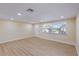 The brightly lit living room features sleek, wood-look flooring and neutral paint at 5102 Peacock, Holiday, FL 34690