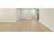 Spacious living room with wood-look floors, leading to a doorway and a closet at 5102 Peacock, Holiday, FL 34690