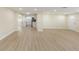 Bright and airy living room featuring modern flooring and an open layout leading to the kitchen at 5102 Peacock, Holiday, FL 34690